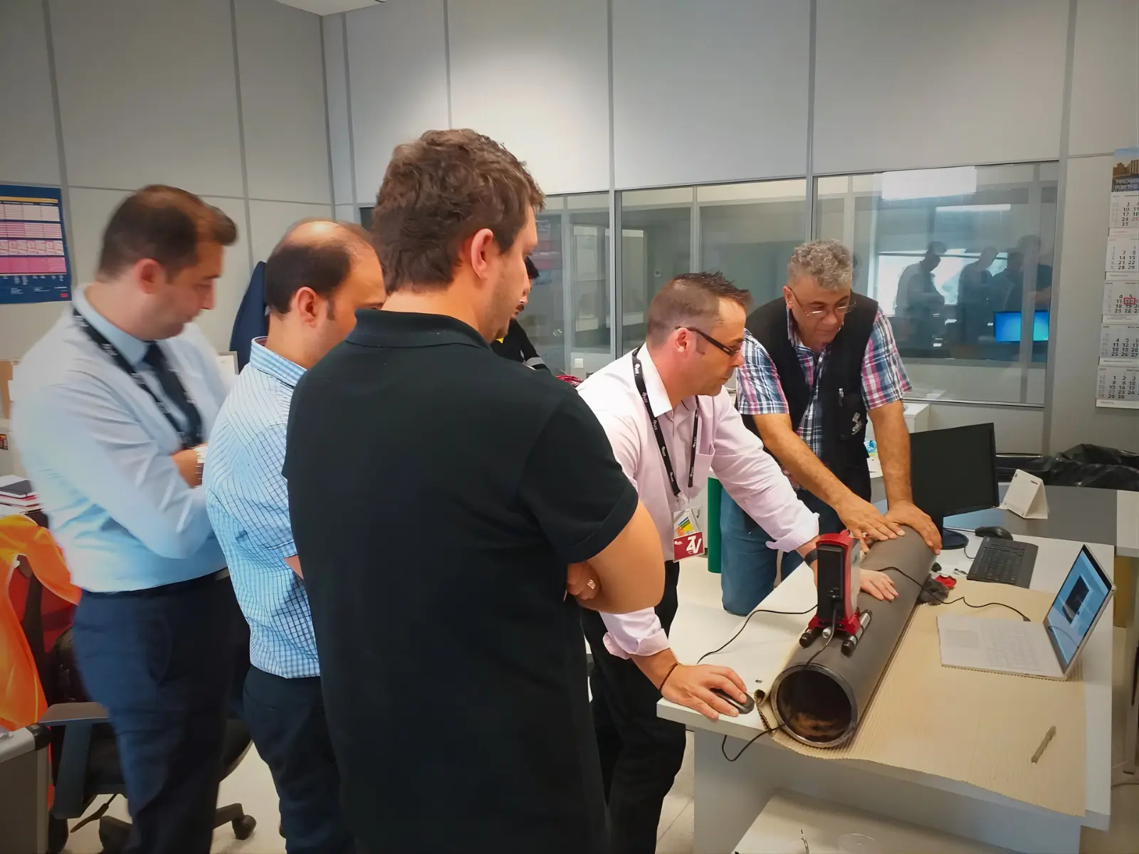 People gather around the AniCAM in the flexo press room